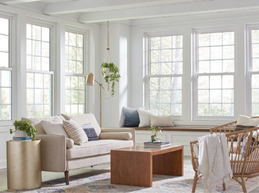 Regency white double hung windows with colonial grid pattern installed in a sunroom