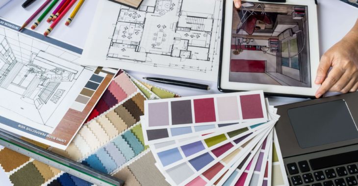A designer looking at colour swatches for a design